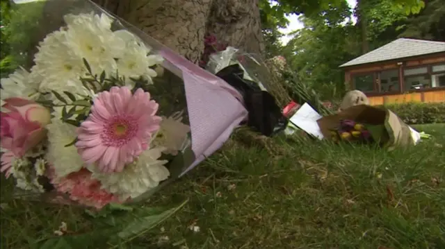 Flowers left outside the gates of Drayton Manor in memory of 11-year-old Evha Jannath