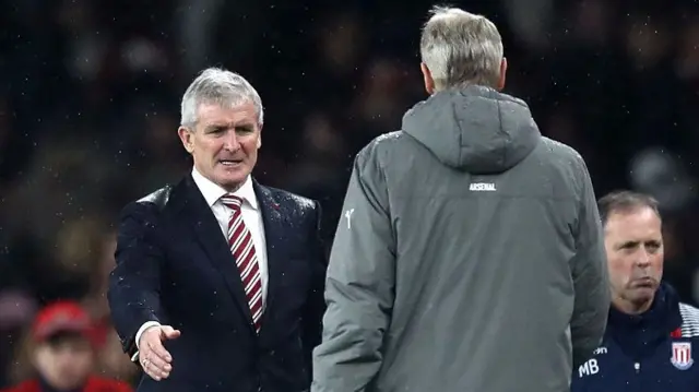 Mark Hughes, Manager of Stoke City (L) and Arsene Wenger, Manager of Arsenal (R) shake hands after the final whistle