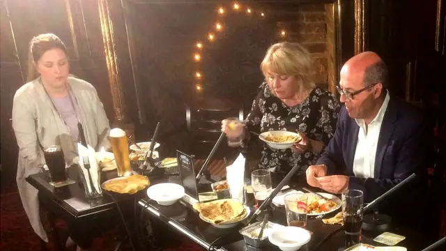 Nick Robinson with focus group members eating