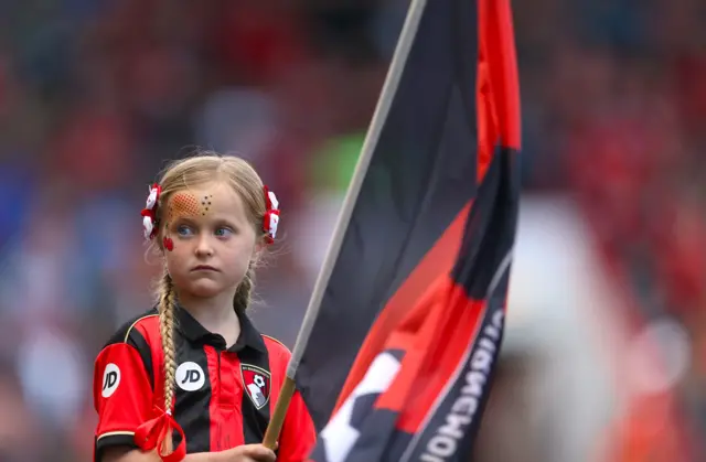 Bournemouth players walk out with children on the pitch