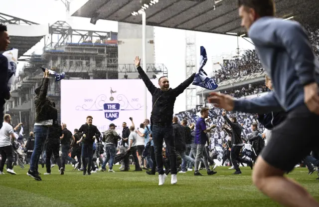 Fans rush onto the pitch