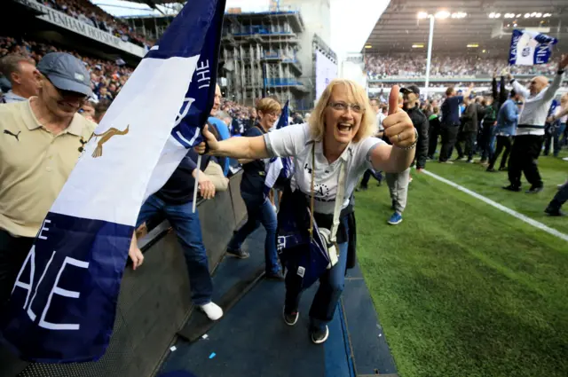 Fan celebrates on the pitch