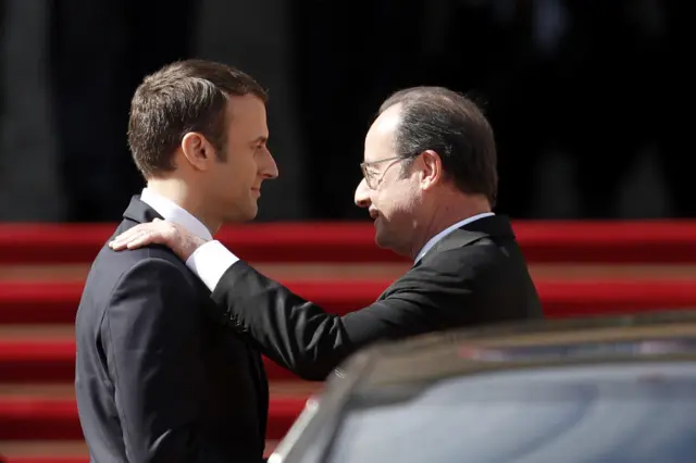 French outgoing President Francois Hollande (R) is escorted by his successor Emmanuel Macron as he leaves the Elysee presidential Palace at the end of their handover ceremony and prior to Macron"s formal inauguration as French President on May 14, 2017 in Paris.