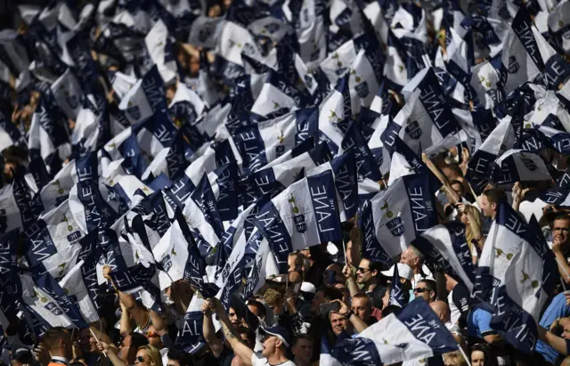 Spurs fans hold The Lane flags