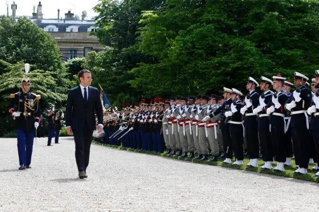 French President Emmanuel Macron (C) reviews troops in the gardens of the Elysee presidential Palace following his formal inauguration ceremony as French President on May 14, 2017 in Paris.