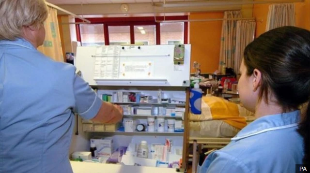 Nurses with medicine trolley