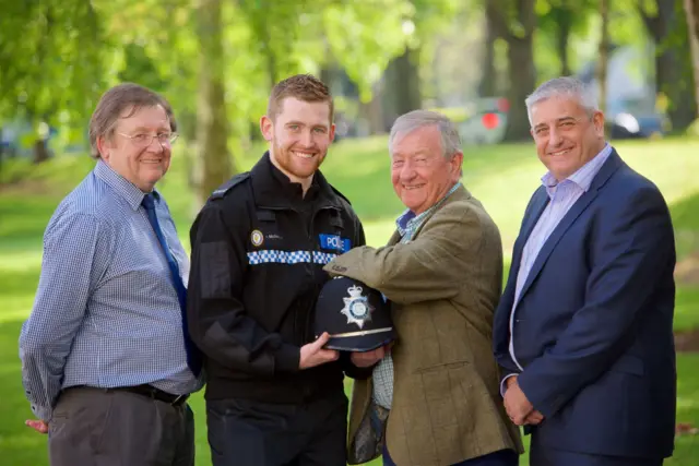 Adam in uniform flanked left to right by father Andy, grandad John and uncle Ian, who also served the force