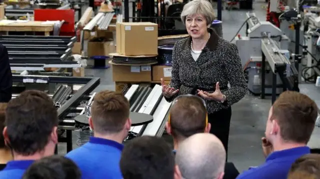 Theresa May speaking to factory workers