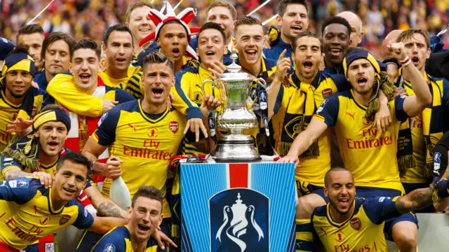 Arsenal celebrate with the FA Cup trophy