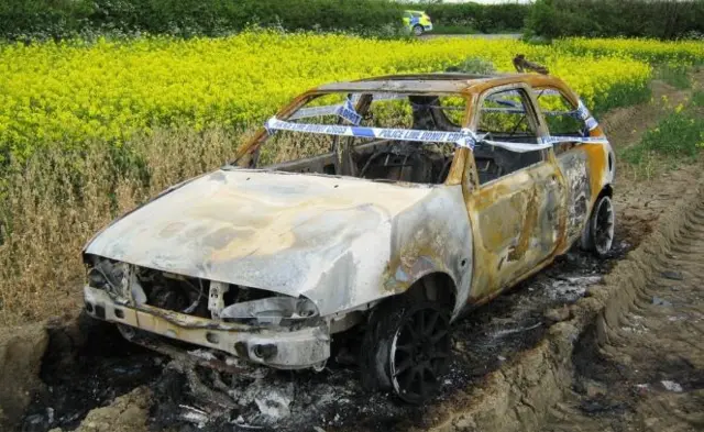 A car has been torched and left abandoned in a field in Broseley