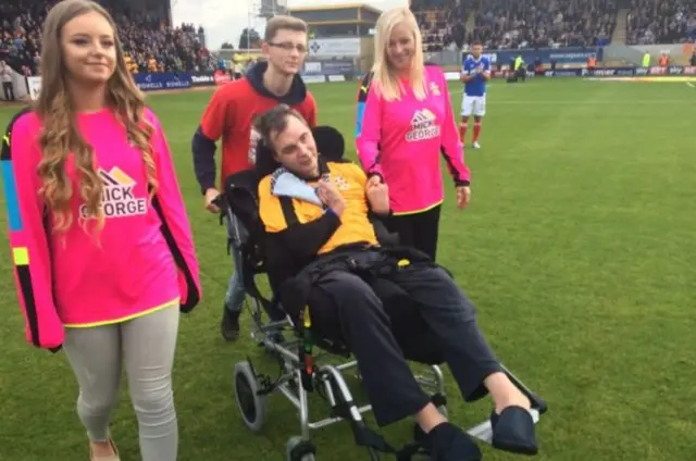 Simon on pitch at Cambridge Utd