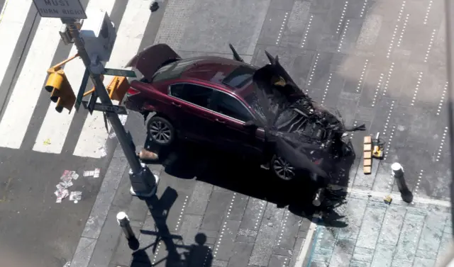 A vehicle sits atop a bollard after multiple people were injured when a vehicle struck numerous pedestrians in Times Square in New York City, New York, USA, 18 May 2017.