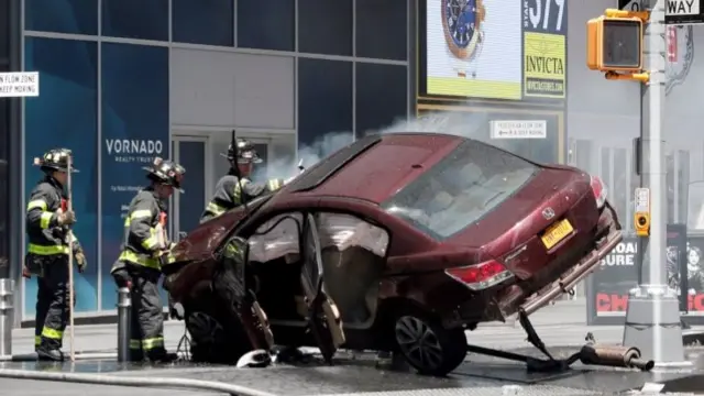 A vehicle that struck pedestrians and later crashed is seen on the sidewalk in Times Square, New York City