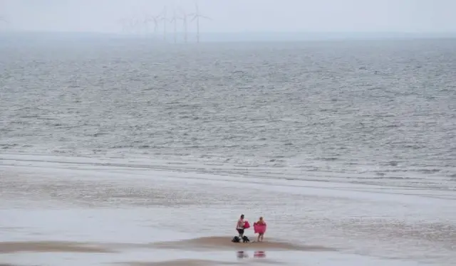 Swimmers on the beach at Saltburn