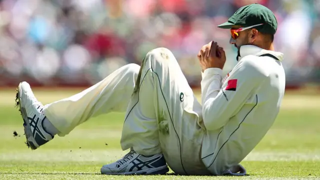 Nathan Lyon of Australia catches a ball