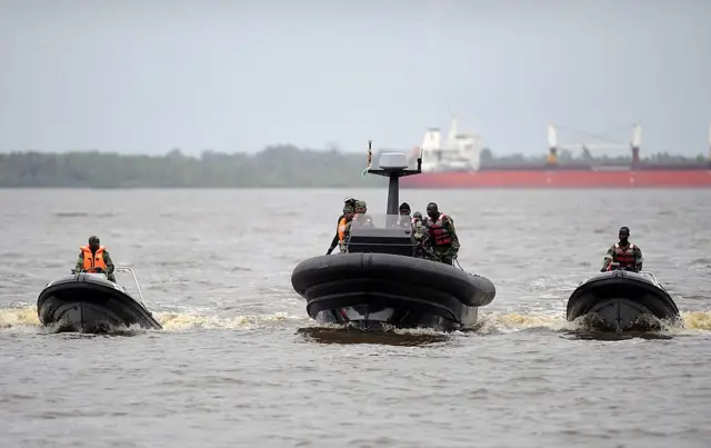 Soldiers of the Ivorian navy commandos steer speedboats newly purchased by Ivorian navy from France at Abidjan military base,