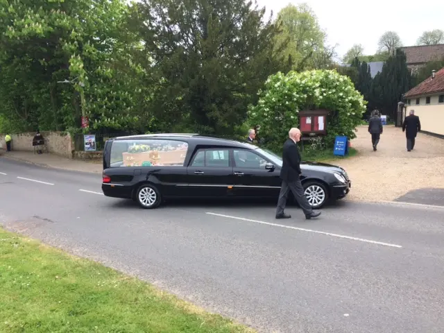 The hearse with Dominic's coffin