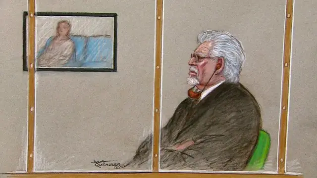 Court sketch of Rolf Harris in the dock while a witness gives evidence