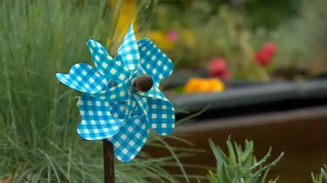 Toy windmill in memorial garden