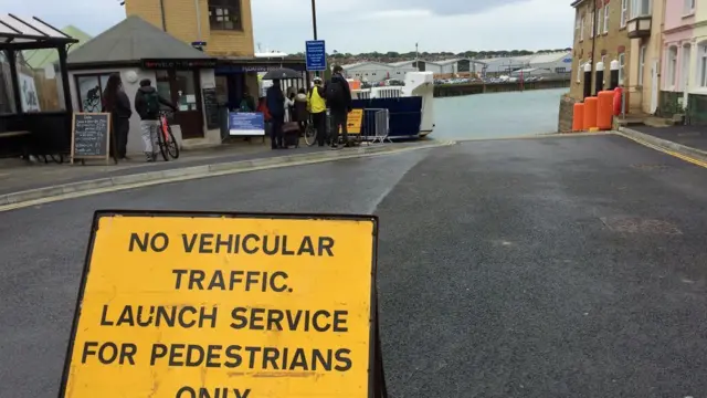 Suspended chain ferry sign