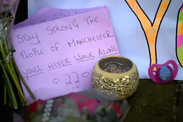 Lit candle and letter to victims of Manchester bomb attack