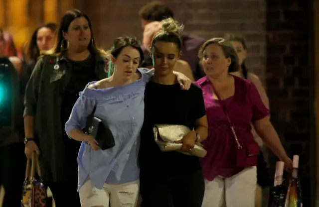 Police escort members of the public from the Manchester Arena