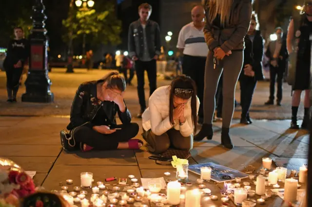 Members of the public attend a candlelit vigil at Albert Square in Manchester, 23 May