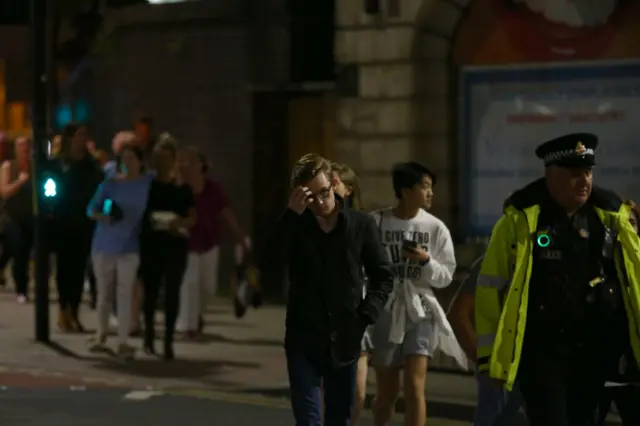 Police escort members of the public from the Manchester Arena