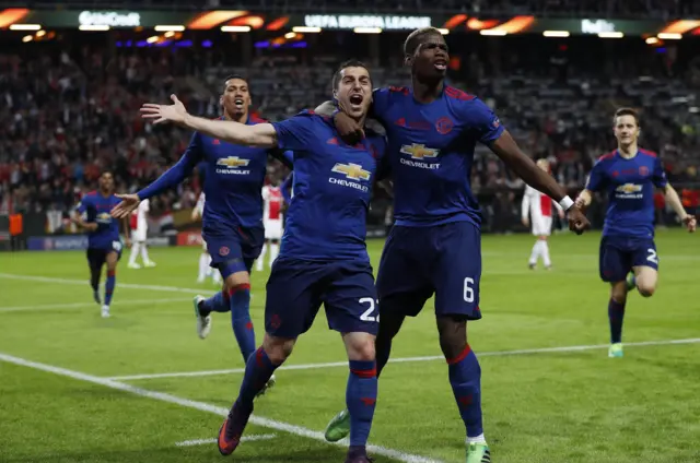 Henrikh Mkhitaryan celebrates scoring their second goal with Paul Pogba