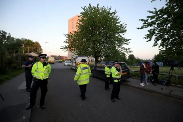 Police outside flats in Blackley, Manchester