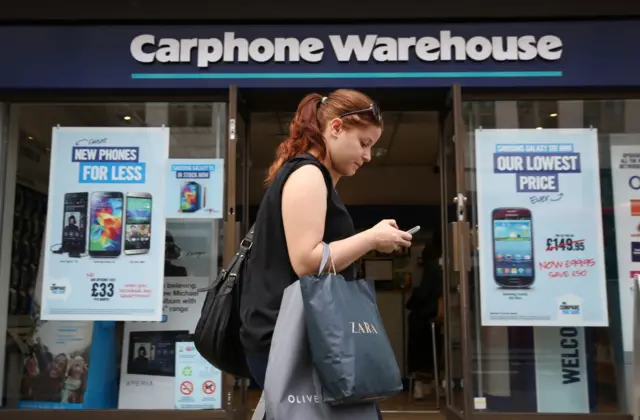 Woman outside Carphone Warehouse store