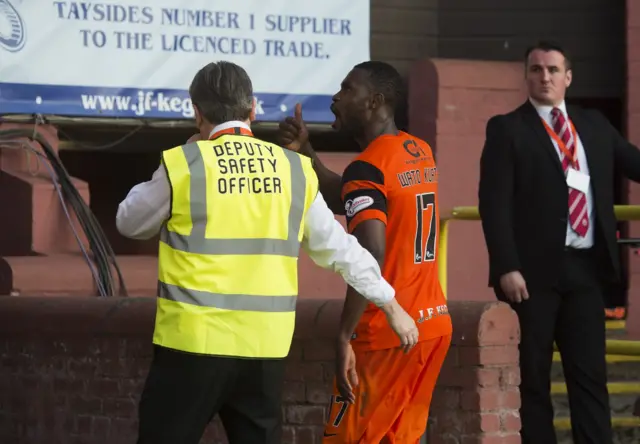 Wato Kuate shouts at the home fans at Tannadice