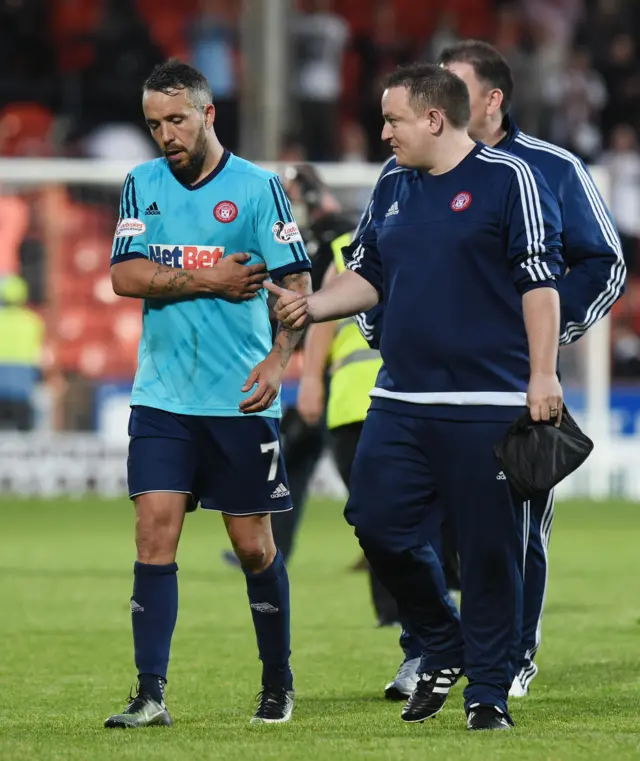 Accies midfielder Dougie Imrie holds his injured ribs