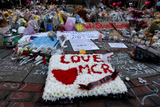 Flowers and messages of condolence are left for the victims