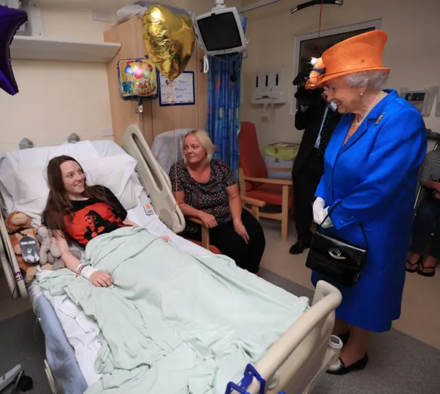 The Queen speaks to Millie Robson, 15, from Co Durham, and her mother, Marie, during a visit to the Royal Manchester Children's Hospital