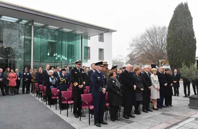 People gather at the memorial service at the British High Commission in Canberra, Australia