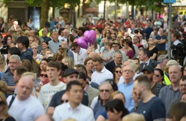 People gather for a minute's silence in St Ann's Square