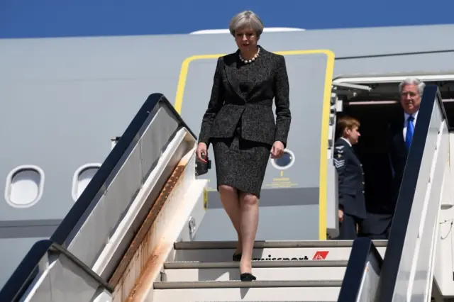 Theresa May arrives at Abelag Airport near Brussels, Belgium, to attend a Nato meeting