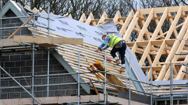 Roofer working on house