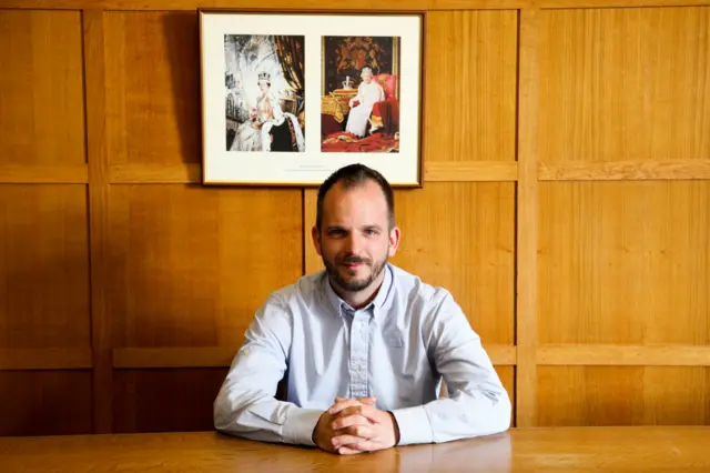 Garry Ratcliffe, county councillor sits in the council chamber in Hay-on-Wye