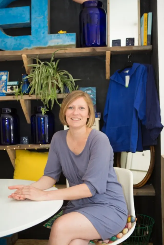 Hannah Burson sits in her bar, the Old Electric Shop, Hay-on-Wye