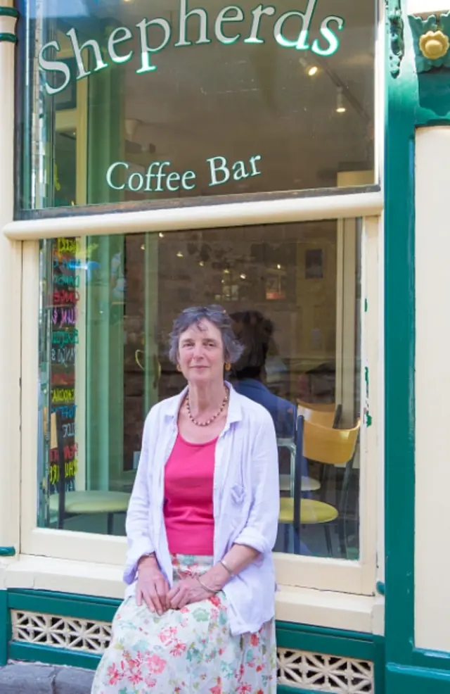 Juliet Noble sits outside Shepherds Ice Cream Parlour in Hay-on-Wye