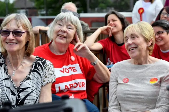 Supporters look-on as Lord John Prescott (not pictured) delivers a stump speech at Ashton United Football Club