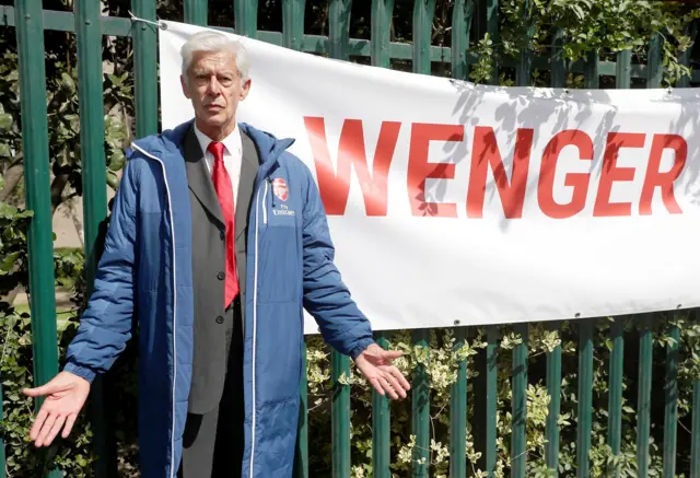 An Arsene Wenger lookalike poses for a picture