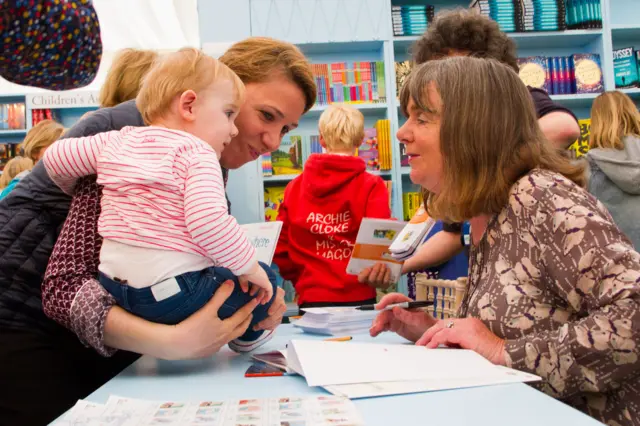 Julia Donaldson signs a book for a young fan at the Hay Festival