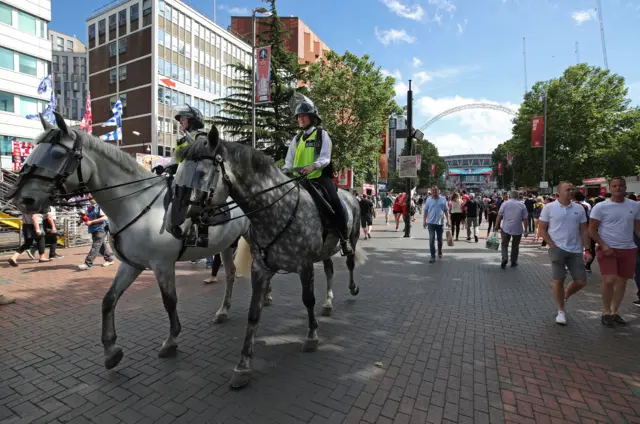 Mounted police watch fans ahead of the match