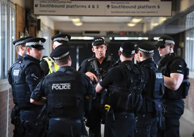 Police hold a team talk at Wembley Station