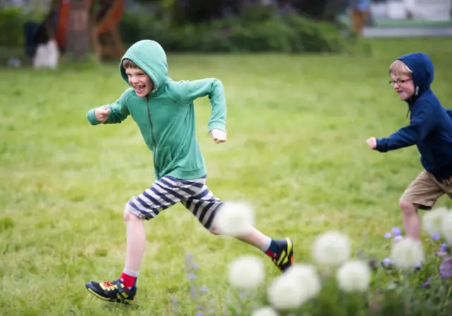 Children run across the Hay Festival site
