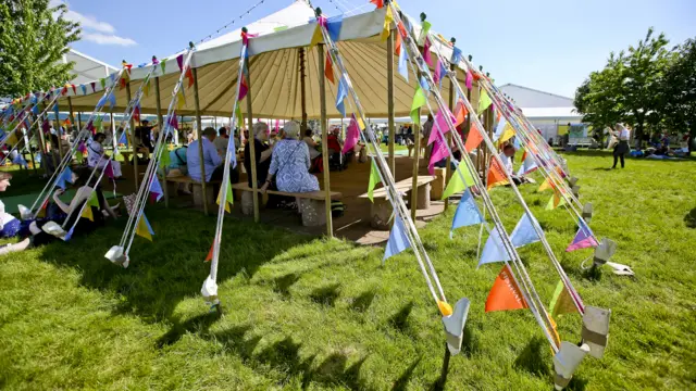People sitting under the tent