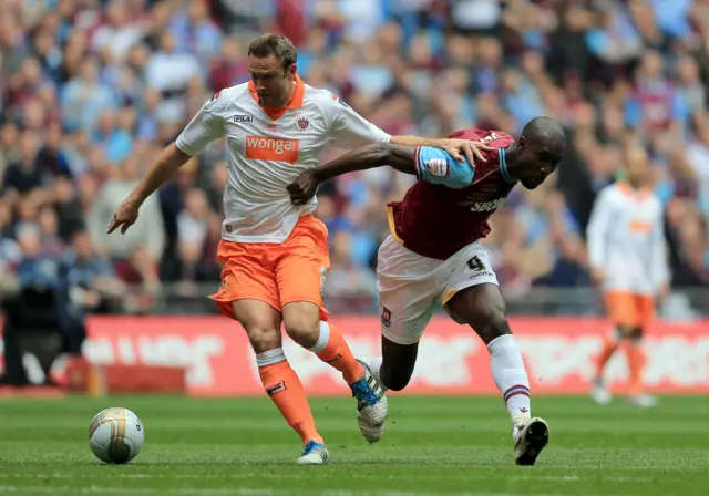 Ian Evatt and Carlton Cole battle